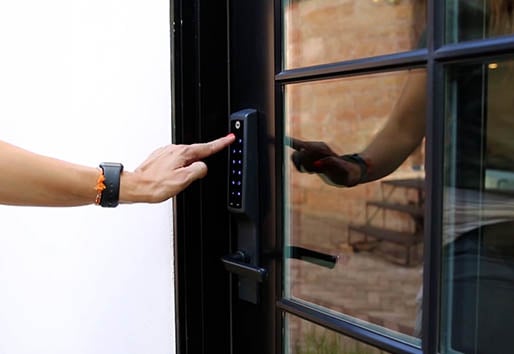 Closeup on person using Yale Assure Lock